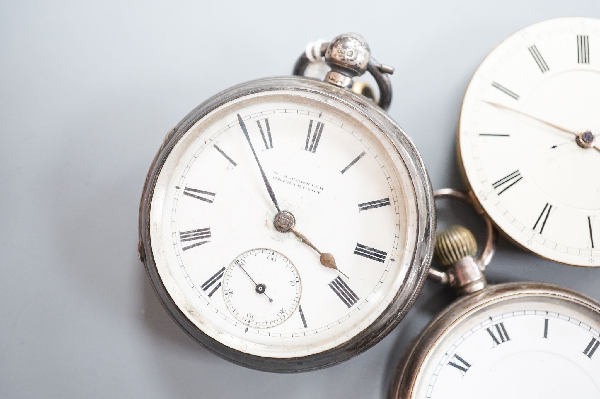 A late Victorian silver keywind open faced pocket watch, retailed by Cornish, Oakehampton, one other silver pocket watch and a pocket watch movement.